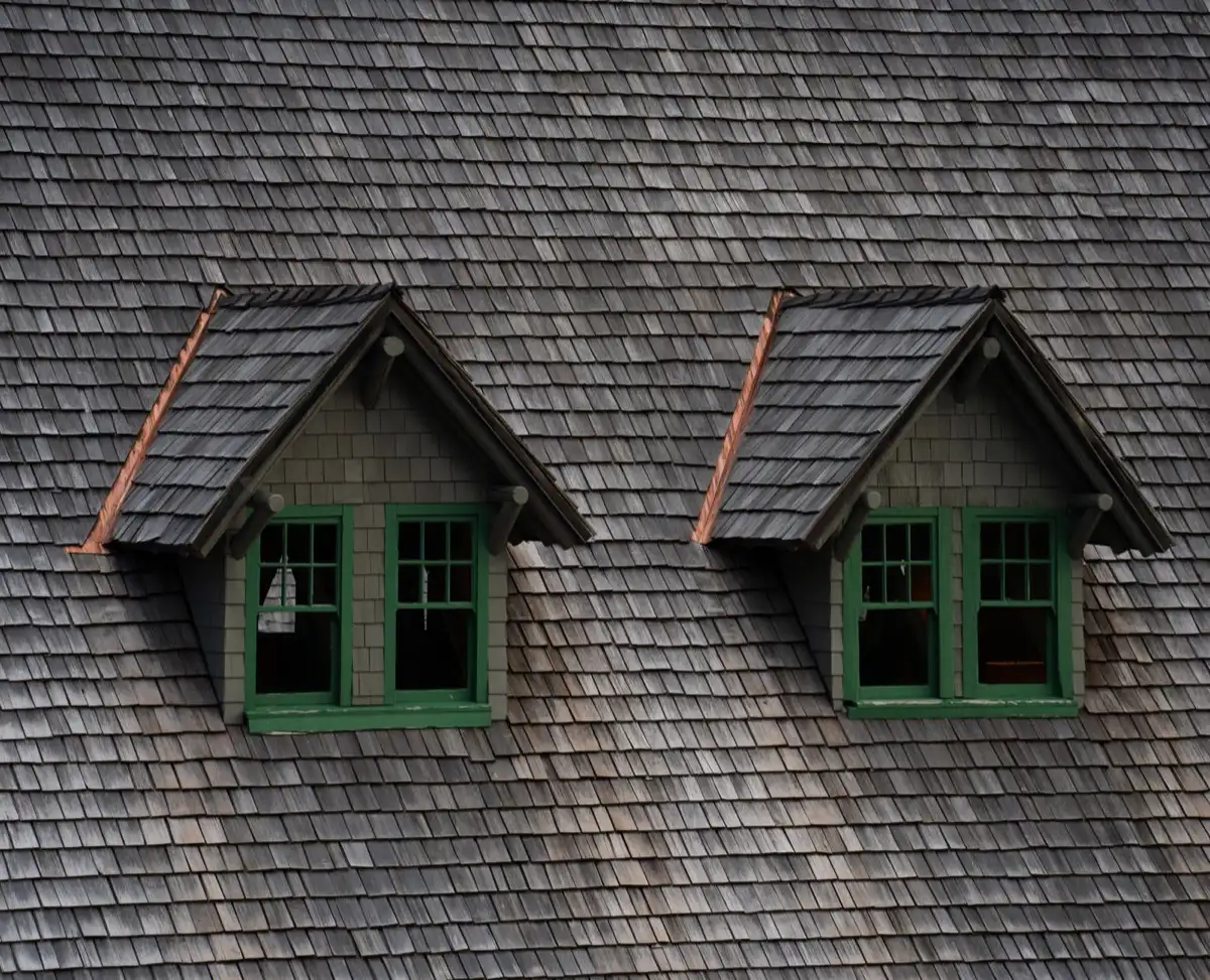 Dormers on a shingle roof in Cedar Rapids, IA, where step flashing and kickout flashing carry water past the walls